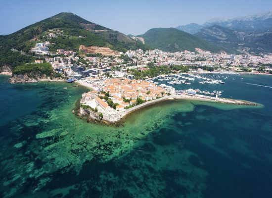 Aerial photo of the Old Town of Budva on the coast of the Adriatic Sea, Montenegro, Europe. Photo was taken from the helicopter. Wide-angle lens.